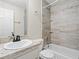 Bathroom featuring tiled shower-tub combo, vanity, and modern fixtures at 4546 Malibu St, Orlando, FL 32811