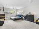 This bedroom features a modern color scheme, ceiling fan, window and large black dresser at 4546 Malibu St, Orlando, FL 32811