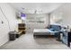 This bedroom features a modern color scheme, ceiling fan, window and large black dresser at 4546 Malibu St, Orlando, FL 32811