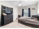 This bedroom features a modern color scheme, ceiling fan, window and large black dresser at 4546 Malibu St, Orlando, FL 32811