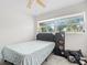 This bedroom features a modern color scheme, ceiling fan, and bright windows at 4546 Malibu St, Orlando, FL 32811