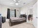 This bedroom features a modern color scheme, ceiling fan, window, and entrance to dining area at 4546 Malibu St, Orlando, FL 32811