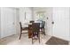 Bright dining area with a round table, four chairs, and natural light from the window at 4546 Malibu St, Orlando, FL 32811