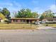 Charming single-story home with a well-maintained yard, mature landscaping, and paved driveway at 4546 Malibu St, Orlando, FL 32811