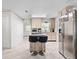 Bright kitchen with tiled floors, stainless steel refrigerator, and center island with seating at 4546 Malibu St, Orlando, FL 32811