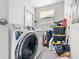 Functional laundry area with modern washer and dryer, plus storage containers for household items and supplies at 4546 Malibu St, Orlando, FL 32811