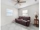 Cozy living room features a brown leather sofa, decorative lamp and plenty of natural light at 4546 Malibu St, Orlando, FL 32811
