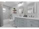 Bright bathroom features double vanity, modern fixtures, and tub with stylish tile surround at 4901 Lindsay Ct, Orlando, FL 32821