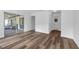 Bright bedroom with wood-look vinyl flooring, white walls and a screened-in porch at 4901 Lindsay Ct, Orlando, FL 32821