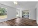 Well-lit bedroom with vinyl flooring, white walls, ceiling fan and a screened-in porch at 4901 Lindsay Ct, Orlando, FL 32821