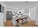 Open-concept kitchen with a breakfast bar, stainless steel appliances, and modern white cabinetry at 4901 Lindsay Ct, Orlando, FL 32821