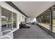 Large screened lanai with carpeting and outdoor furniture provides space to relax at 4901 Lindsay Ct, Orlando, FL 32821