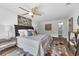 Spacious main bedroom with a king bed, nice rug, a ceiling fan, and a view to the connected bathroom at 4901 Lindsay Ct, Orlando, FL 32821