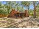 Private backyard with an screened-in porch, mature trees and a cozy outdoor fireplace at 5 W Village Dr, Oviedo, FL 32765
