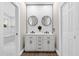 Stylish bathroom featuring a double sink vanity, hexagonal backsplash and modern fixtures at 5 W Village Dr, Oviedo, FL 32765