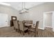 Bright dining room featuring modern chandelier, skylight and wood-look tile at 5 W Village Dr, Oviedo, FL 32765