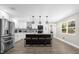 Kitchen featuring white cabinetry, stainless steel appliances, and island seating at 5 W Village Dr, Oviedo, FL 32765