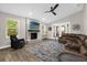 Living room boasts a stone fireplace, vaulted ceiling, and sliding glass doors at 5 W Village Dr, Oviedo, FL 32765