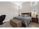 A bright main bedroom with a sitting area, neutral tones and beautiful wood look ceramic tile flooring at 5 W Village Dr, Oviedo, FL 32765