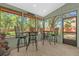 Serene screened-in porch furnished with stylish bar-height tables and chairs, perfect for outdoor relaxation at 5 W Village Dr, Oviedo, FL 32765