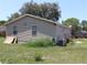 Back view of the home with a patio and yard at 5054 Mcdonald Rd, Zellwood, FL 32798