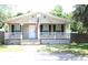Charming single-story home featuring a covered front porch, a welcoming entrance, and neatly landscaped surroundings at 5054 Mcdonald Rd, Zellwood, FL 32798