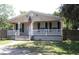 Charming single-story home featuring a covered front porch, a welcoming entrance, and neatly landscaped surroundings at 5054 Mcdonald Rd, Zellwood, FL 32798