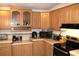 Well-appointed kitchen featuring wood cabinets and modern appliances with laminate countertops at 5054 Mcdonald Rd, Zellwood, FL 32798