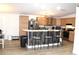 Well-equipped kitchen featuring stainless steel appliances, a breakfast bar, and wood cabinets at 5054 Mcdonald Rd, Zellwood, FL 32798