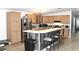 Well-equipped kitchen featuring stainless steel appliances, a breakfast bar, and wood cabinets at 5054 Mcdonald Rd, Zellwood, FL 32798