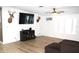Bright living room with new floors, windows, and a mounted television at 5054 Mcdonald Rd, Zellwood, FL 32798