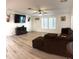 Spacious living room with hard surface flooring and a comfortable sectional couch at 5054 Mcdonald Rd, Zellwood, FL 32798