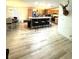 Bright, open concept space seamlessly connects the dining area and kitchen with hardwood floors at 5054 Mcdonald Rd, Zellwood, FL 32798