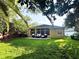 Backyard patio with exterior seating, privacy wall, and lush green grass at 563 Pleasant Grove Dr, Winter Springs, FL 32708