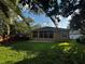 Wide view of backyard, brick patio, house and screen room at 563 Pleasant Grove Dr, Winter Springs, FL 32708