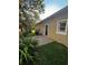 Exterior view of the house with a brick patio, lawn and landscaping at 563 Pleasant Grove Dr, Winter Springs, FL 32708