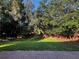 Secluded backyard featuring lush landscaping and a brick wall for added privacy and charm at 563 Pleasant Grove Dr, Winter Springs, FL 32708