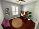 Cozy bedroom with natural light, modern desk, hardwood floors, and stylish accents at 563 Pleasant Grove Dr, Winter Springs, FL 32708