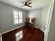 Bright bedroom with hardwood floors, a ceiling fan, and a built-in desk at 563 Pleasant Grove Dr, Winter Springs, FL 32708