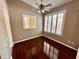 Bedroom featuring hardwood floors, neutral walls, shutters on the windows and ceiling fan at 563 Pleasant Grove Dr, Winter Springs, FL 32708