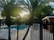 Community pool area with a private gate and lush palm trees, offering a serene retreat at 563 Pleasant Grove Dr, Winter Springs, FL 32708