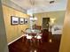 Elegant dining room with a glass table, stylish chandelier, and views into the living area at 563 Pleasant Grove Dr, Winter Springs, FL 32708