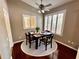 Cozy dining room with dark wood table, seating for four, and bright natural light at 563 Pleasant Grove Dr, Winter Springs, FL 32708