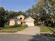Beautiful single Gathering home with mature trees, a well-manicured lawn, and a two car garage at 563 Pleasant Grove Dr, Winter Springs, FL 32708