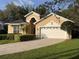 Charming single Gathering home with a well-maintained lawn, mature landscaping, and a two car garage at 563 Pleasant Grove Dr, Winter Springs, FL 32708