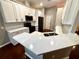 Bright kitchen featuring quartz countertops, white cabinets and stainless steel appliances at 563 Pleasant Grove Dr, Winter Springs, FL 32708
