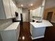 Updated kitchen with white cabinets, stainless appliances, and open layout at 563 Pleasant Grove Dr, Winter Springs, FL 32708