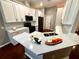 Modern kitchen featuring quartz countertops, white cabinetry, and stainless steel appliances at 563 Pleasant Grove Dr, Winter Springs, FL 32708