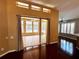Living room with hardwood floors leading to sun room through sliding glass doors at 563 Pleasant Grove Dr, Winter Springs, FL 32708