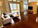 Open-concept living room with hardwood floors, modern decor, and access to the patio at 563 Pleasant Grove Dr, Winter Springs, FL 32708